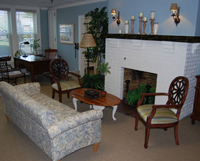 A new couch and new chairs at the fireplace area.